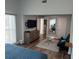 Bright main bedroom boasts wood-look floors, TV, and a relaxing sitting area at 247 Rex Pl # G, Madeira Beach, FL 33708