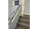 Carpeted staircase with a granite-topped handrail at 247 Rex Pl # G, Madeira Beach, FL 33708
