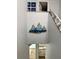 Stairway with marine artwork leads to the main bathroom at 247 Rex Pl # G, Madeira Beach, FL 33708