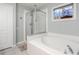 Bathroom featuring a separate shower, tub, and window at 25348 Flying Ebony Ln, Wesley Chapel, FL 33544