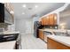 Bright kitchen featuring white countertops, wood cabinets, and stainless steel appliances at 25348 Flying Ebony Ln, Wesley Chapel, FL 33544