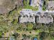 Aerial shot of townhomes showcasing lush landscaping, parking, and a glimpse of a pool at 2712 Conch Hollow Dr, Brandon, FL 33511