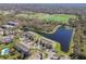 Aerial view of the townhome community showcasing a pond, green spaces, and recreational fields at 2712 Conch Hollow Dr, Brandon, FL 33511