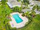 Aerial view of a resort-style pool surrounded by lounge chairs and tropical landscaping at 2712 Conch Hollow Dr, Brandon, FL 33511
