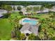 Aerial view of the neighborhood pool surrounded by tropical landscaping and townhome buildings at 2712 Conch Hollow Dr, Brandon, FL 33511