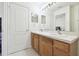 Bright bathroom featuring a double sink vanity, mirror, and tile flooring at 2712 Conch Hollow Dr, Brandon, FL 33511