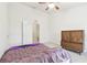 This bright bedroom boasts a ceiling fan, neutral carpet, and a view into the closet at 2712 Conch Hollow Dr, Brandon, FL 33511