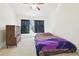 Cozy bedroom featuring a ceiling fan, dresser, and a window with natural light and dark curtains at 2712 Conch Hollow Dr, Brandon, FL 33511