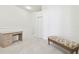 Bedroom with neutral carpet, a simple desk, and a bench with decorative upholstery at 2712 Conch Hollow Dr, Brandon, FL 33511