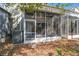 The cozy screened lanai has a door and a view of the green backyard and house features at 2712 Conch Hollow Dr, Brandon, FL 33511