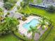 Community pool with lounge chairs, palm trees, and a covered pavilion for residents to relax and enjoy at 2712 Conch Hollow Dr, Brandon, FL 33511
