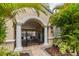Gated pool entrance framed by palm trees and lush landscaping at 2712 Conch Hollow Dr, Brandon, FL 33511
