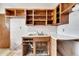 Outdated kitchen featuring wood cabinets, a stainless steel sink, with damaged walls, and a damaged floor at 2903 Florida Blvd, Bradenton, FL 34207