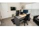 Modern office space with two monitors, a sleek desk, and a comfortable chair at 3251 Silver Date Dr, Wimauma, FL 33598