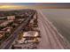 Breathtaking aerial view of a beachfront property at sunset with ocean view at 3351 Gulf Of Mexico Dr, Longboat Key, FL 34228