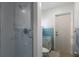 En-suite bathroom with a glass-enclosed shower and blue accent tiles at 3351 Gulf Of Mexico Dr, Longboat Key, FL 34228