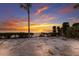 Beautiful beach view with colorful sky, sandy beach and scattered vegetation that enhances the coastal charm at 3351 Gulf Of Mexico Dr, Longboat Key, FL 34228