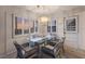 Inviting dining area with a glass table, wicker chairs, and modern lighting at 3351 Gulf Of Mexico Dr, Longboat Key, FL 34228
