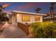 Charming beach house with a wooden walkway and lush green foliage at sunset at 3351 Gulf Of Mexico Dr, Longboat Key, FL 34228