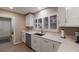 Bright kitchen with white cabinets, quartz counters, and stainless steel sink at 3351 Gulf Of Mexico Dr, Longboat Key, FL 34228