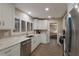 Modern kitchen boasting stainless appliances, white cabinets, and a view to the living room at 3351 Gulf Of Mexico Dr, Longboat Key, FL 34228