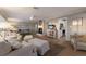 Open living room with fireplace, TV, and comfortable furnishings, flowing into the kitchen at 3351 Gulf Of Mexico Dr, Longboat Key, FL 34228