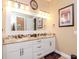 Bathroom with double sink vanity, granite countertop, and decorative mirror at 4302 W San Pedro St, Tampa, FL 33629