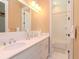 Bright bathroom with double sinks, white cabinets and a shower and bathtub combination at 4302 W San Pedro St, Tampa, FL 33629