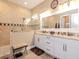 Bright bathroom featuring double vanity with granite countertop and tiled walk-in shower at 4302 W San Pedro St, Tampa, FL 33629