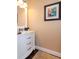 Cozy powder room featuring a white vanity with marble countertop and a framed artwork at 4302 W San Pedro St, Tampa, FL 33629