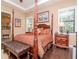 Spacious bedroom features a four-poster bed, a tray ceiling, and hardwood floors at 4302 W San Pedro St, Tampa, FL 33629