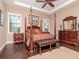 Spacious bedroom with a four-poster bed, tray ceiling, and hardwood floors at 4302 W San Pedro St, Tampa, FL 33629