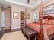Bedroom featuring a four-poster bed, decorative art, and en suite bathroom at 4302 W San Pedro St, Tampa, FL 33629