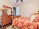 Well-lit bedroom features a wooden dresser and bed frame for a cozy ambiance at 4302 W San Pedro St, Tampa, FL 33629