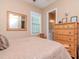 Bedroom featuring a view of the ensuite bathroom, wood blinds and hardwood flooring at 4302 W San Pedro St, Tampa, FL 33629