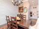 Charming dining space featuring a wood table, stone accent wall and seamless access to a modern kitchen at 4302 W San Pedro St, Tampa, FL 33629