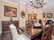 Stunning dining room with a large wooden table, chandelier, and view into the living area at 4302 W San Pedro St, Tampa, FL 33629