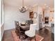 Beautiful dining area with a decorative brick wall, dark wood table, and wrought iron chandelier at 4302 W San Pedro St, Tampa, FL 33629