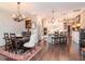 Open concept dining room featuring hardwood floors, a wooden table, and seamless access to the kitchen at 4302 W San Pedro St, Tampa, FL 33629