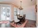 Dining room featuring a wood table with seating for six, modern chandelier, and access to patio at 4302 W San Pedro St, Tampa, FL 33629
