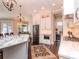 Bright, open kitchen featuring white cabinets, stainless steel appliances, a marble island, and dark hardwood floors at 4302 W San Pedro St, Tampa, FL 33629