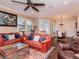 Inviting living room with ample seating, a ceiling fan, and seamless transition to the dining area at 4302 W San Pedro St, Tampa, FL 33629