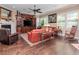 Comfortable living room featuring a fireplace, a ceiling fan, and abundant natural light at 4302 W San Pedro St, Tampa, FL 33629