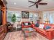 Spacious living room with a ceiling fan, a cozy seating arrangement, and a wall of windows at 4302 W San Pedro St, Tampa, FL 33629