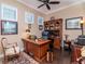 Well-lit office space with a large wooden desk, a built-in bookshelf, and hardwood floors at 4302 W San Pedro St, Tampa, FL 33629