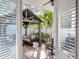 A covered patio area with comfortable seating and privacy, viewed from indoors through opened blinds at 4302 W San Pedro St, Tampa, FL 33629