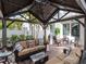 Covered patio featuring comfortable seating, a ceiling fan, and views of the landscaped yard at 4302 W San Pedro St, Tampa, FL 33629