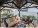 Outdoor covered patio featuring a comfortable wicker sofa with accent pillows and an outdoor ceiling fan at 4302 W San Pedro St, Tampa, FL 33629