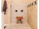 Walk-in shower with wooden stool and multiple shower heads at 4302 W San Pedro St, Tampa, FL 33629