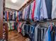 Spacious walk-in closet with custom shelving for clothes and shoes, and hardwood floors at 4302 W San Pedro St, Tampa, FL 33629
